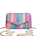 Multicolored quilted handbag with gold chain on a light gray background