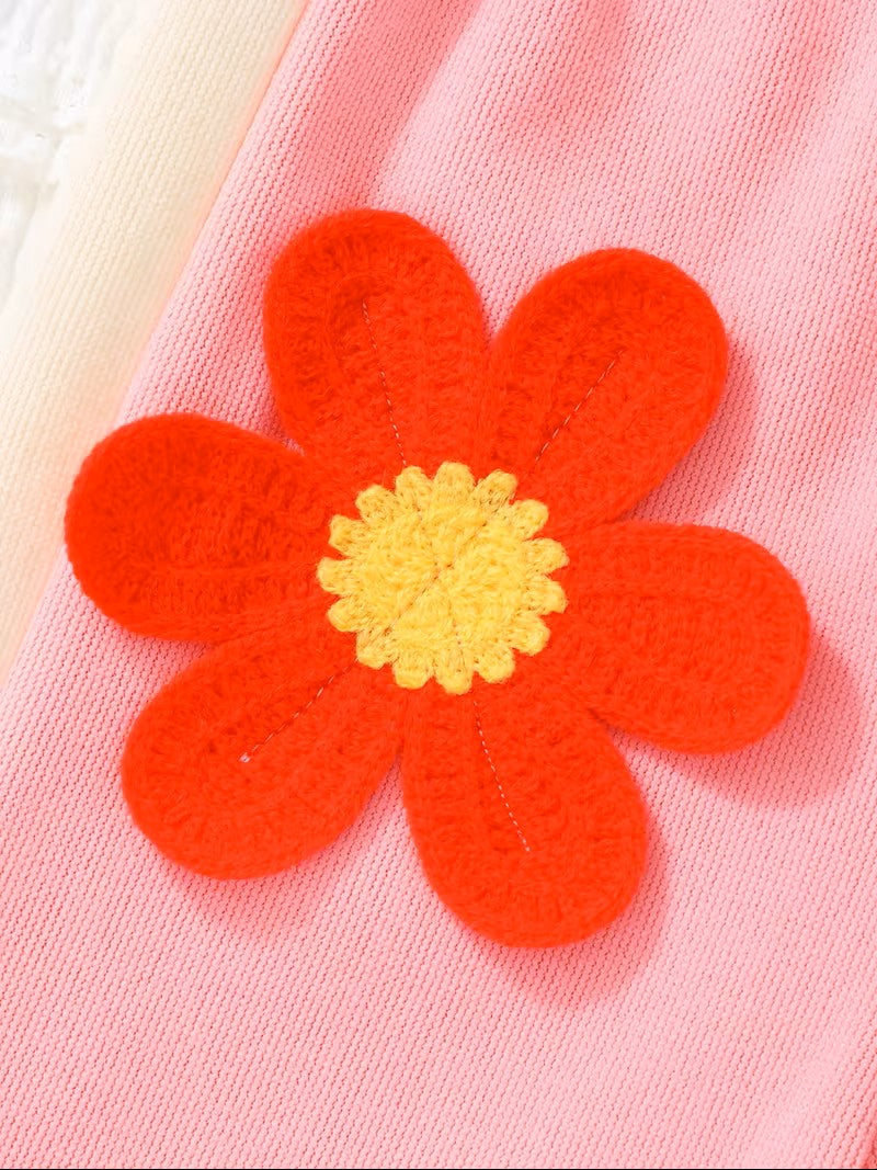 Red flower-shaped object with a yellow center on a pink background