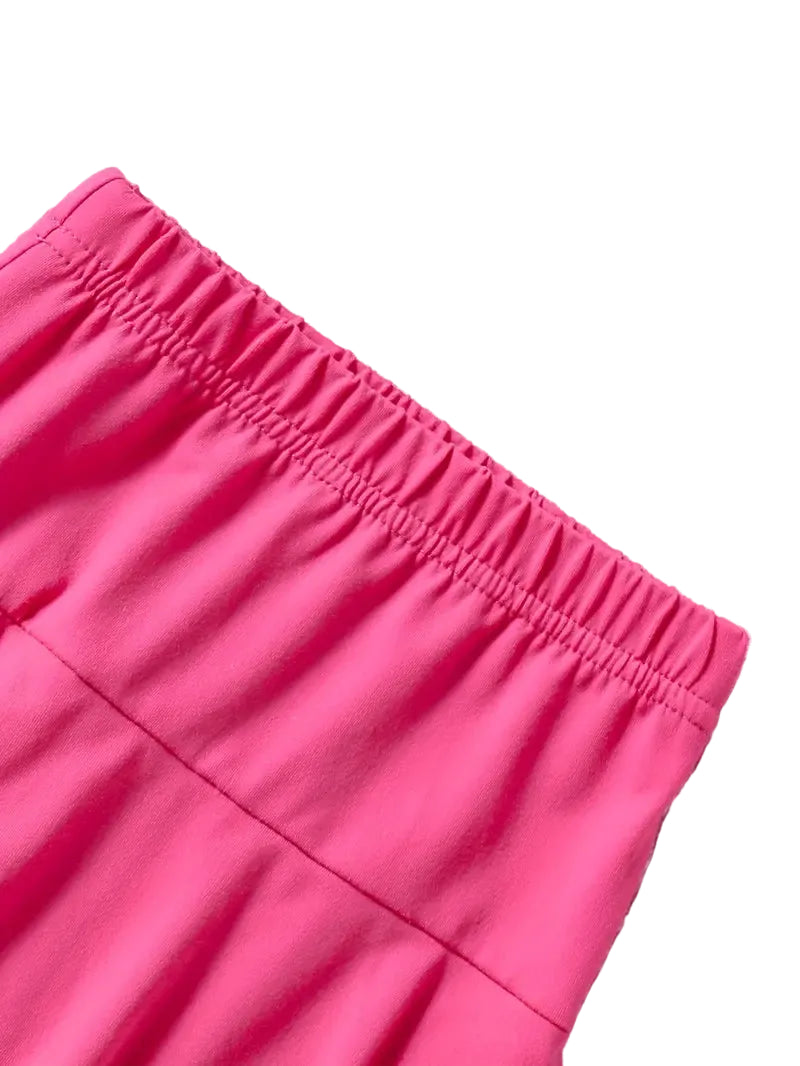 Close-up of a bright pink skirt with a white background