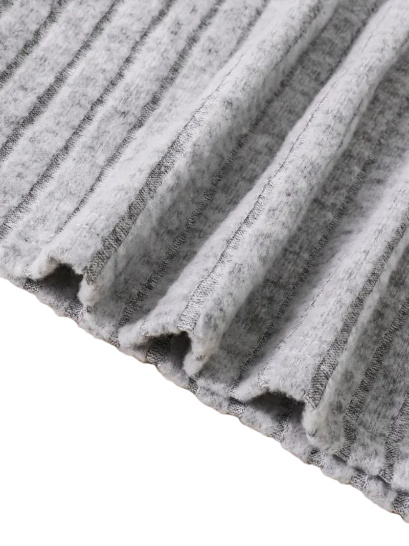 Close-up of a gray pleated fabric on a wooden surface