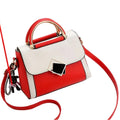 Red and white handbag with a strap on a white surface