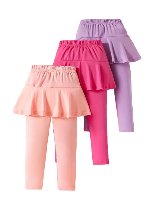 Set of three colorful leggings with ruffled skirts on a white background