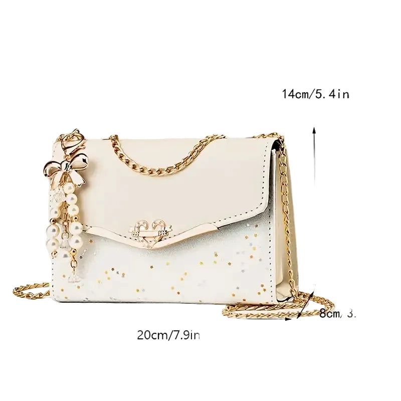White handbag with gold chain and pearl details, shown with measurements on a white background.