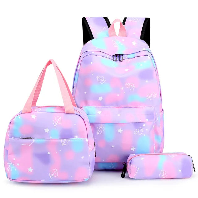 Set of pastel-colored backpack, lunch bag, and pencil case with star pattern on a white background