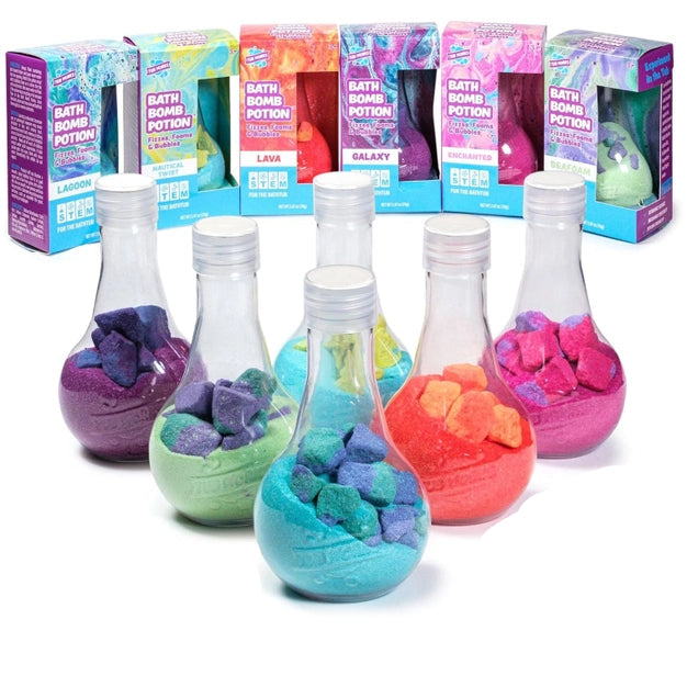 Colorful bath bomb potions in glass bottles with packaging in the background, labeled '6 Pack'.