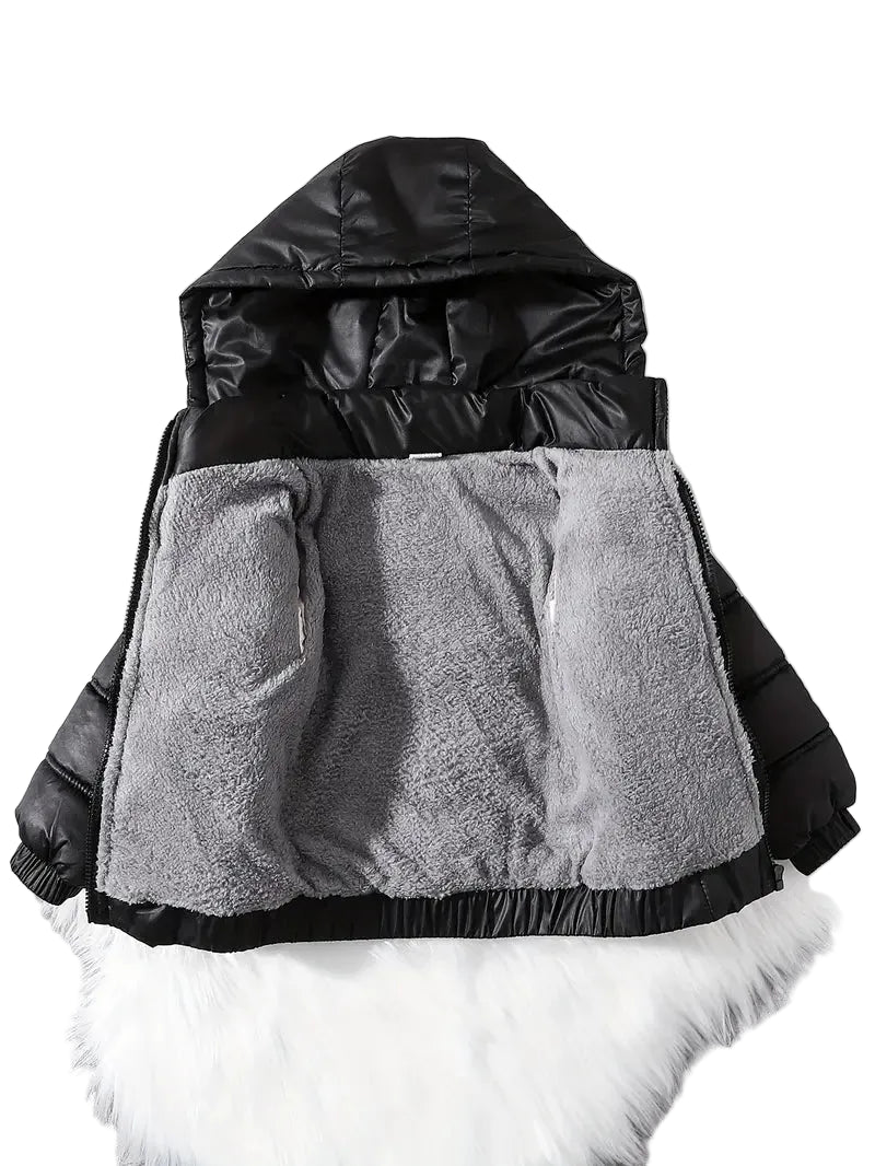 Two-layered jacket with black top and gray bottom on a white fur background