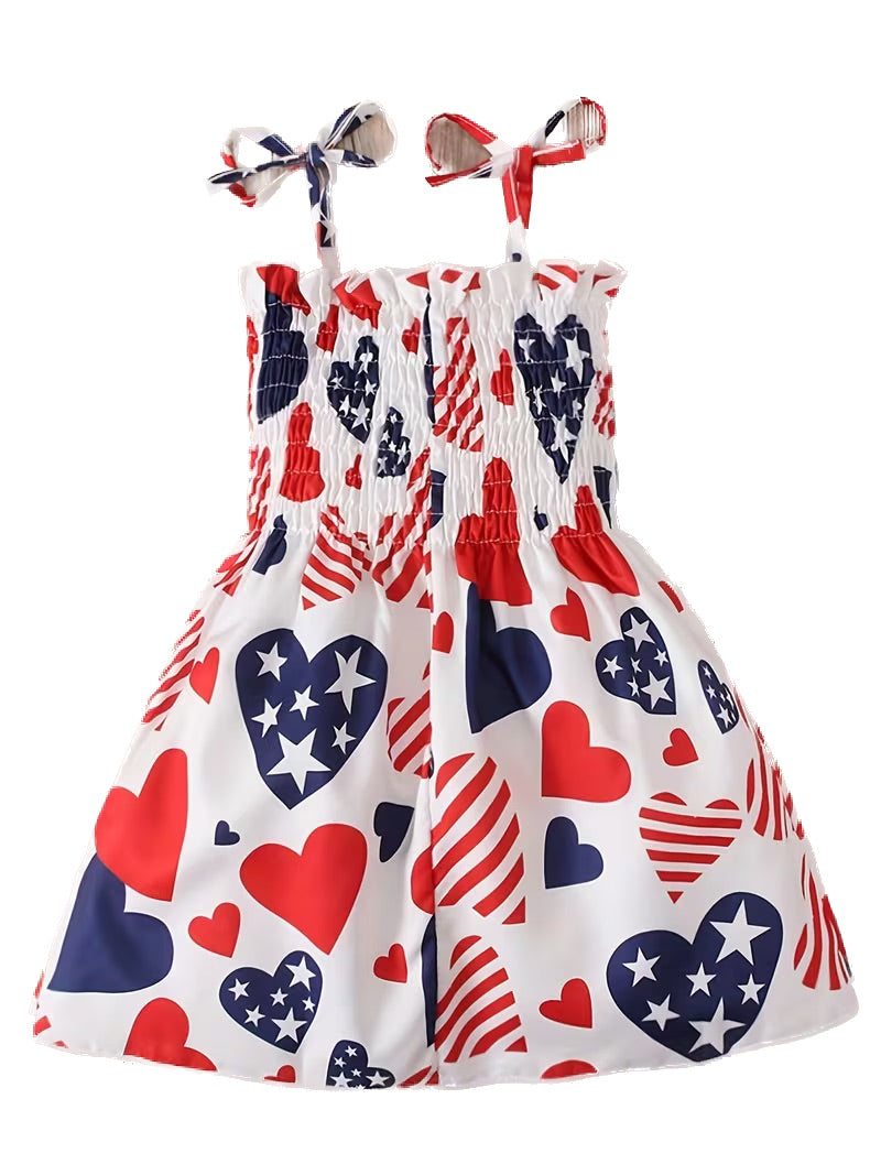 Children's dress with heart and flag pattern on a white background