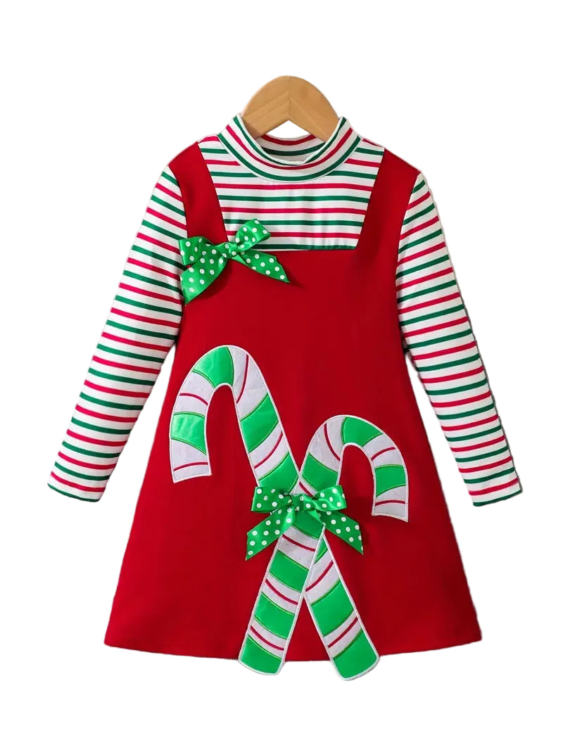 Children's Christmas dress with candy cane design on a hanger
