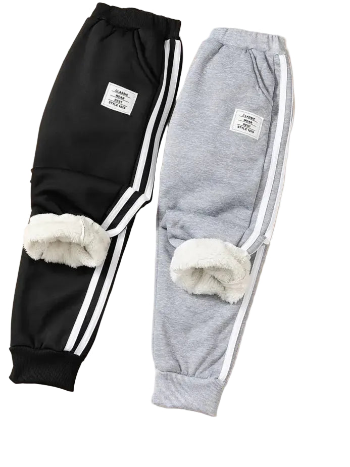 Black and gray sweatpants with white stripes and fur accents on a white background