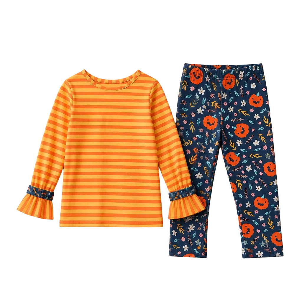 Children's outfit with orange striped shirt and navy leggings with pumpkin pattern on a gray background