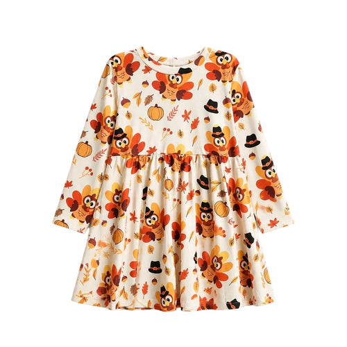 A long-sleeve baby dress with a festive autumn print featuring cartoon owls, pumpkins, acorns, and leaves on a cream background, shown flat against a light gray background.