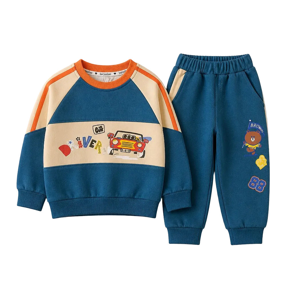 A children's two-piece sweatshirt and jogger set laid flat on a light gray background. The sweatshirt is blue with a cream horizontal chest panel, orange shoulder stripes, and cartoon graphics across the front.