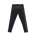 Black leggings with gold text on a light gray background