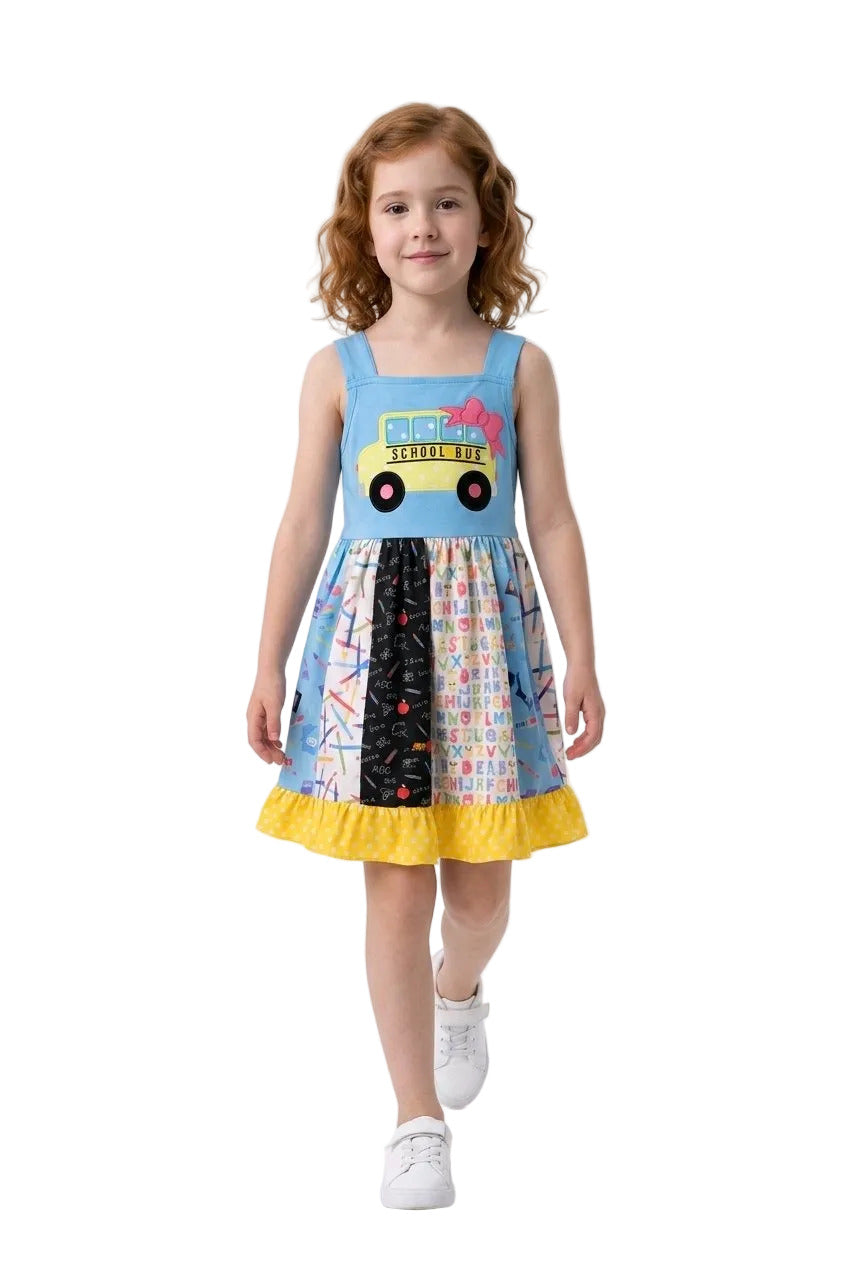 Young girl wearing a colorful dress with a yellow car design on a white background