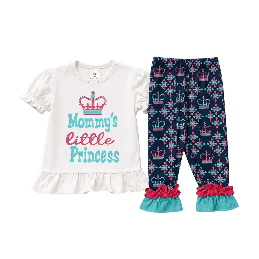 A toddler girl's two-piece outfit set featuring a white short-sleeve ruffle-hem top with 'Mommy's little Princess' text and a crown graphic, paired with navy patterned leggings with pink and teal ruffle cuffs.