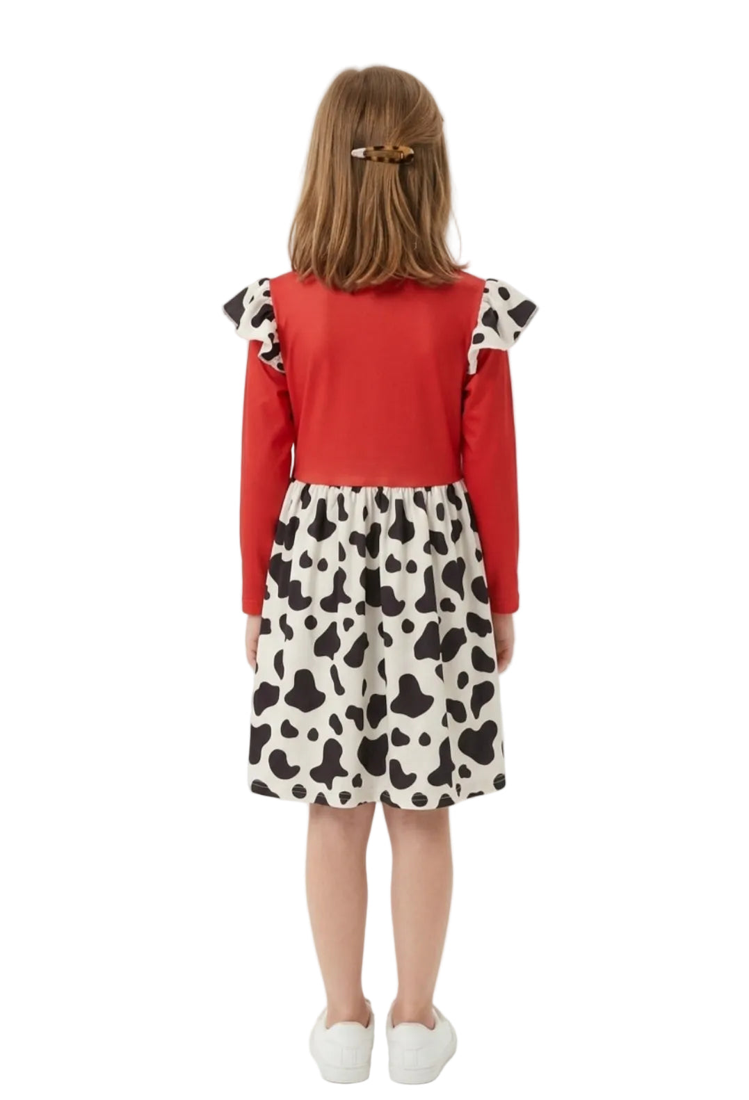 Child wearing a red top and cow print skirt