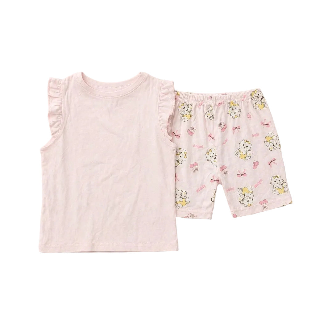 Pink pajama set with ruffled top and floral shorts on a light gray background