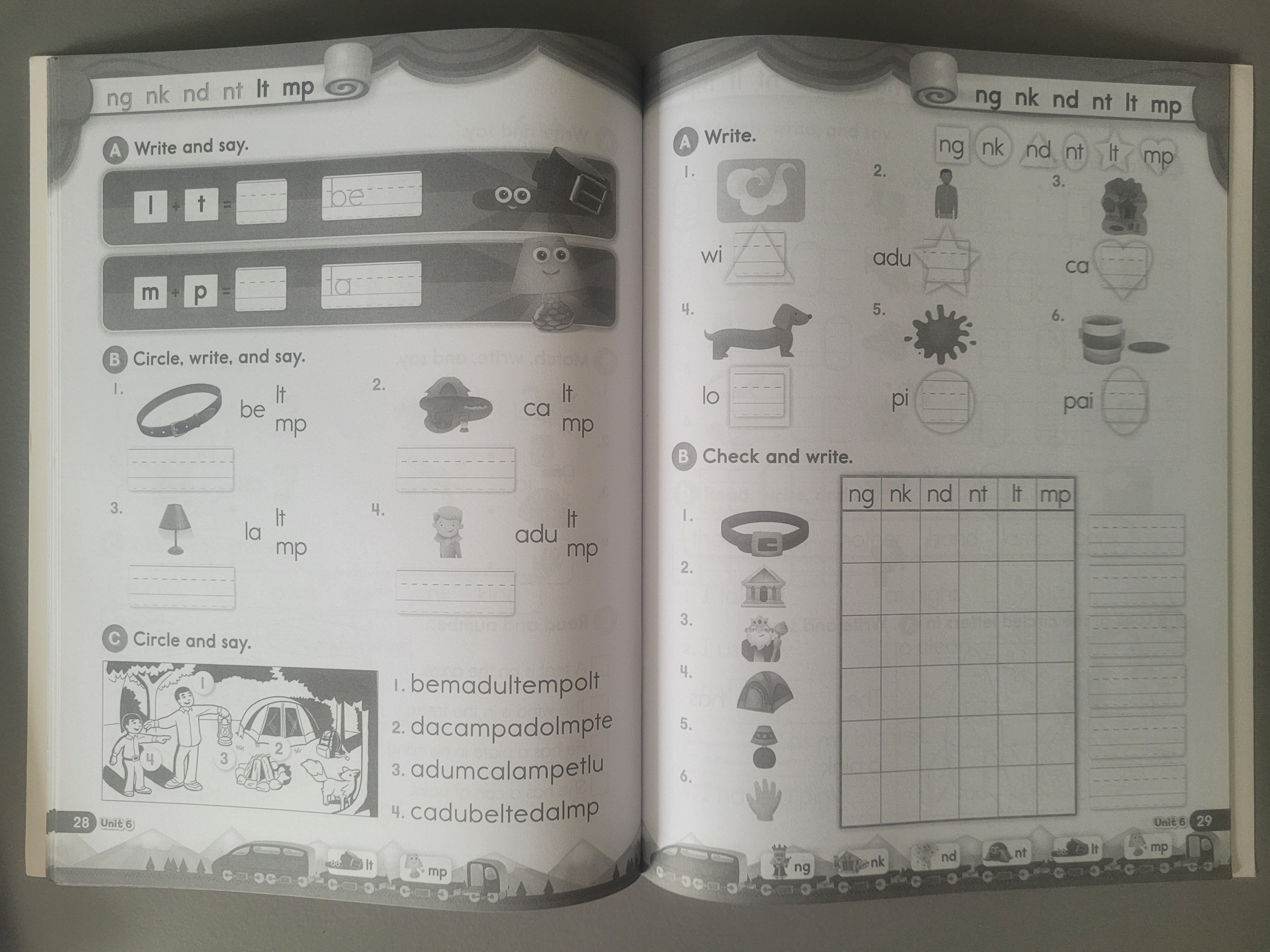 Open book with educational content on phonics and vocabulary, featuring illustrations and text.