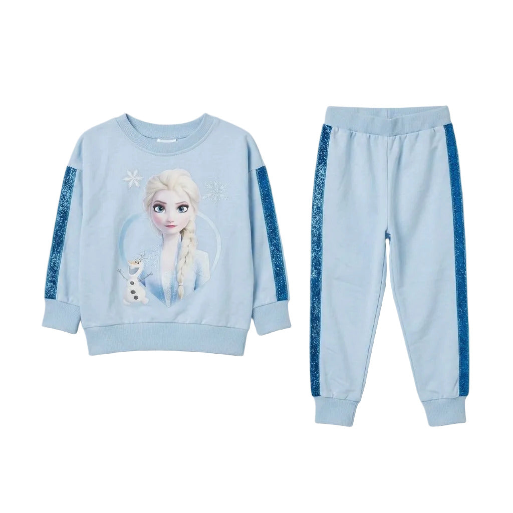A children's two-piece lounge set featuring a light blue sweatshirt with a Frozen Elsa graphic and glittery blue sleeve panels, paired with matching jogger pants with glittery blue side stripes, shown on a light gray background.