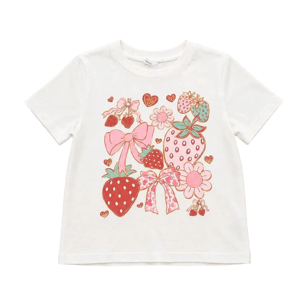 A white short-sleeve kids' t-shirt featuring a colorful graphic print of strawberries, bows, and flowers in pink, red, and green, laid flat on a light gray background.