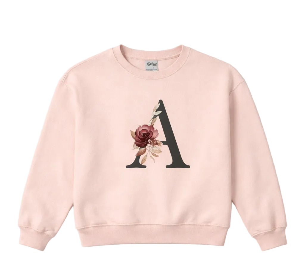 Pink sweatshirt with a floral letter 'A' design on a light gray background