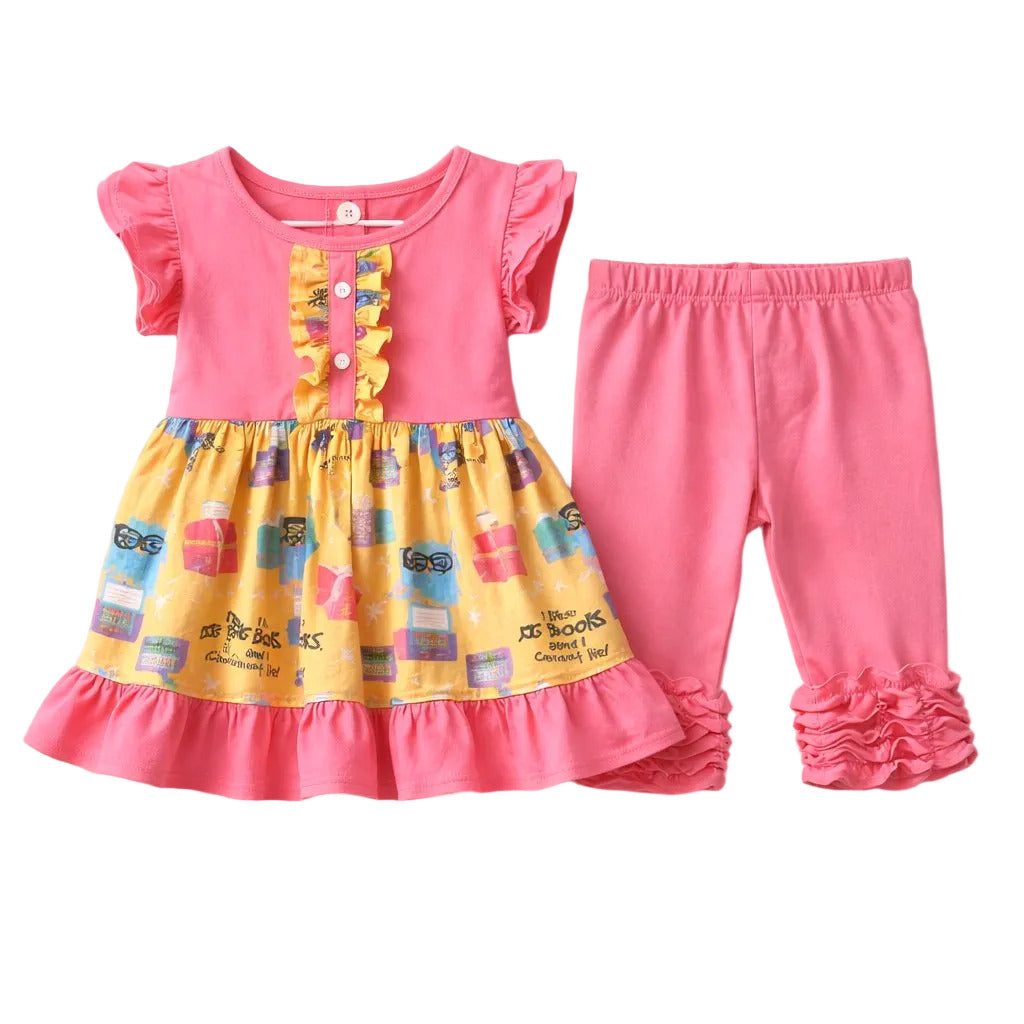 Children's outfit with pink top and yellow patterned shorts on a white background