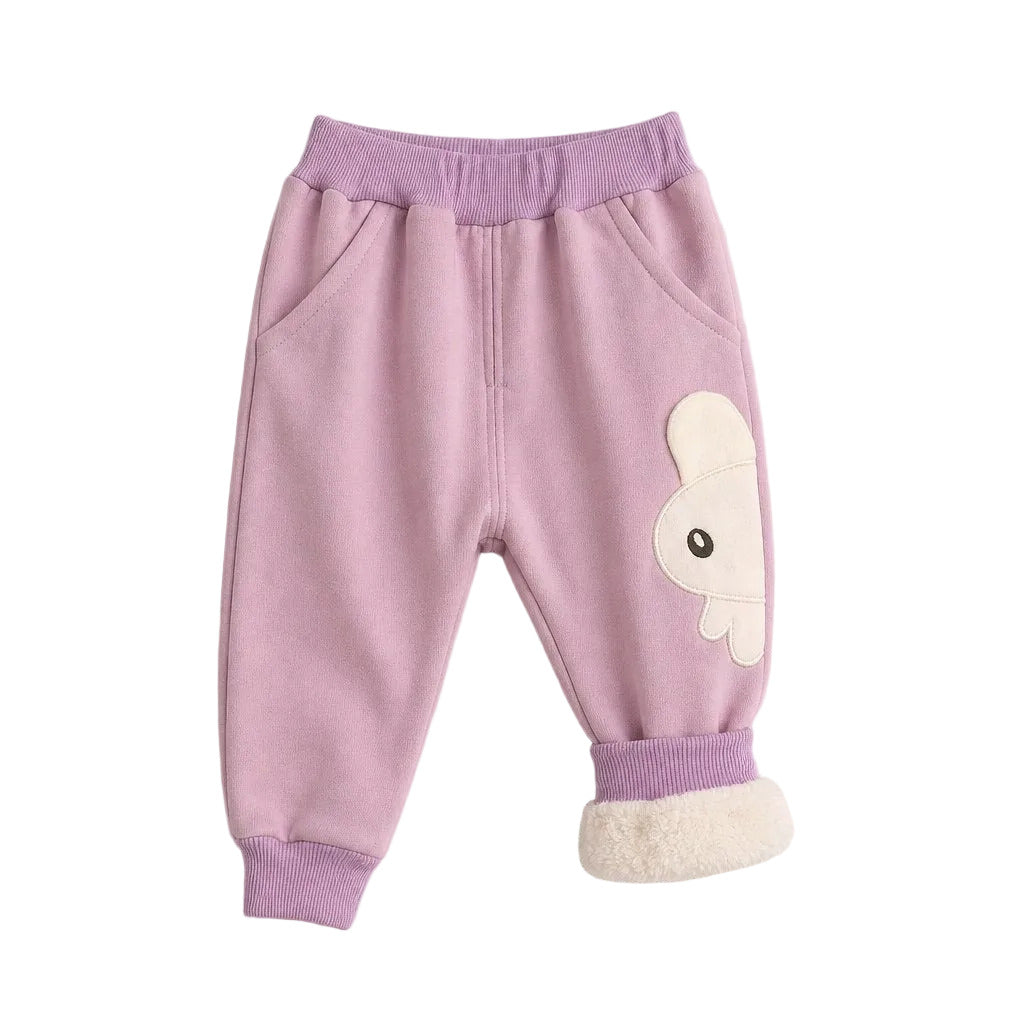 A pair of children's jogger pants in light purple, featuring a cream-colored bunny applique on the left leg, a matching purple elastic waistband, and a soft cream fleece lining visible at the ankle cuffs, laid flat on a light gray background.