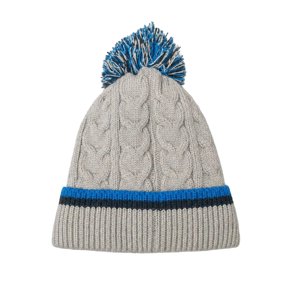 A light gray cable-knit beanie hat with a blue and white pom-pom on top and a blue and black striped ribbed cuff, shown on a light gray background.