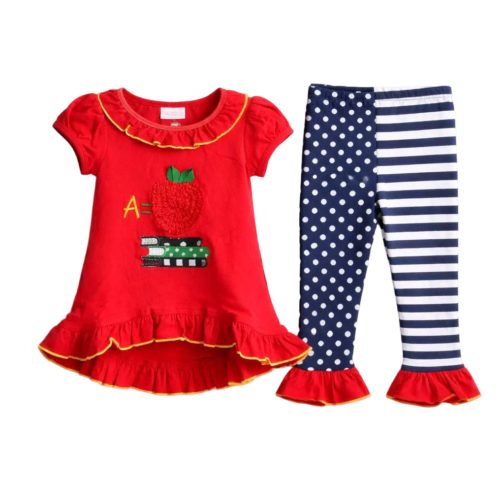 Red dress with apple design and matching leggings with polka dots and stripes on a light gray background