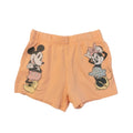 Peach shorts with cartoon character prints on a light gray background