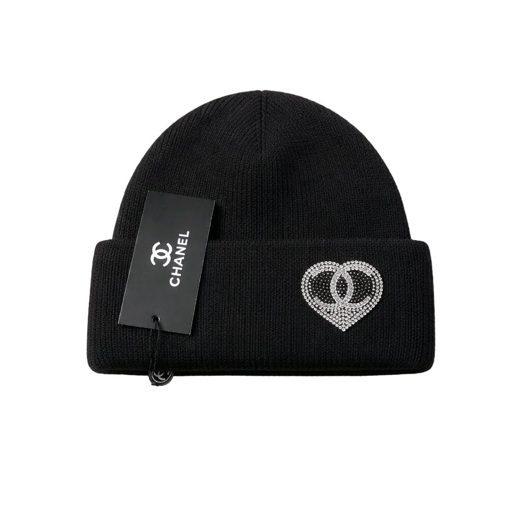 Black beanie with heart design and Chanel tag on a white background