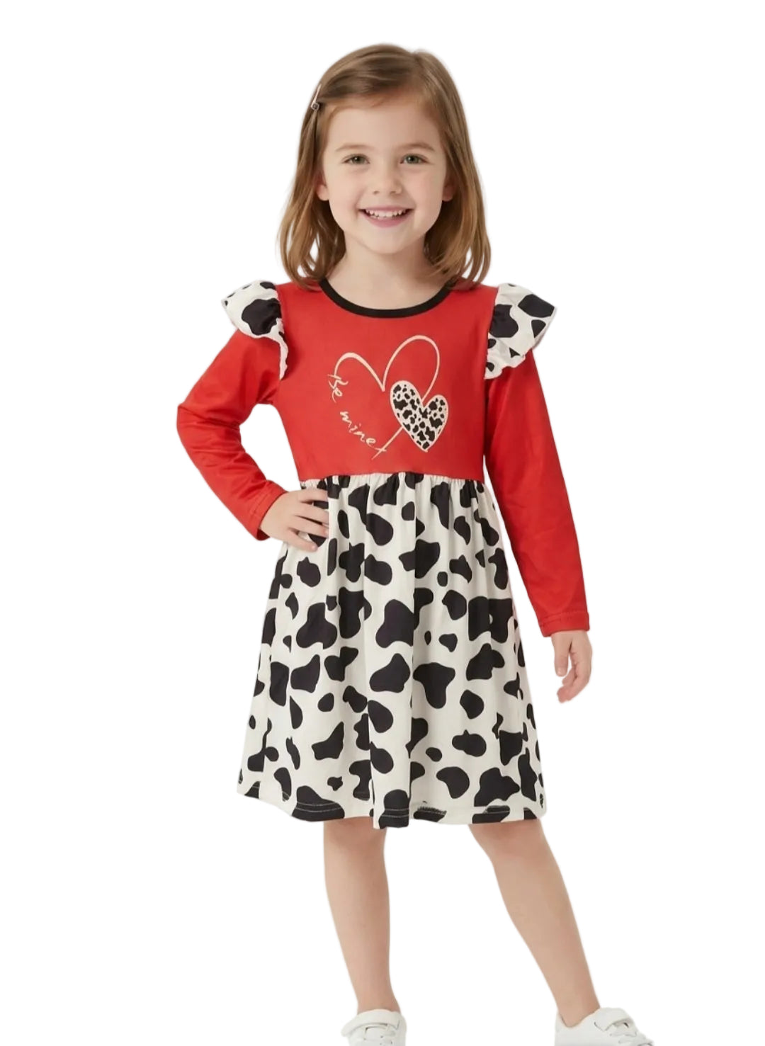 Young girl wearing a red top and cow print skirt on a white background