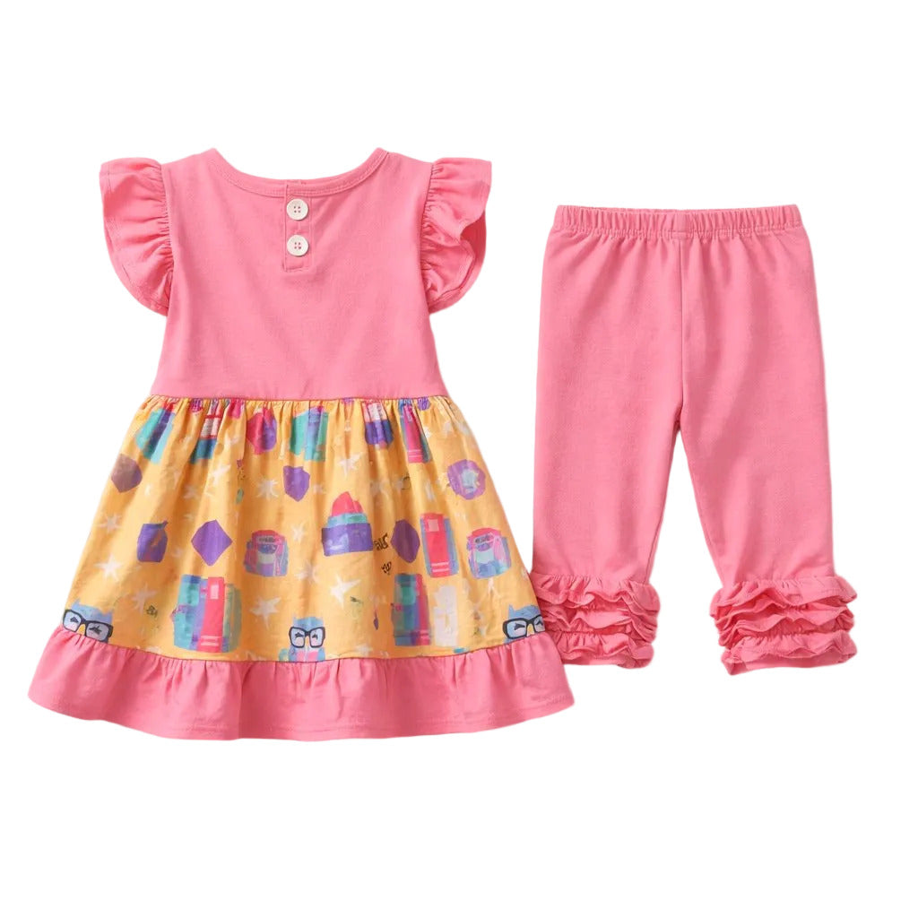 Children's outfit with pink top and yellow dress with colorful pattern on a white background