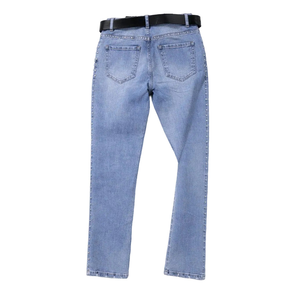 Light blue jeans with a black belt on a white background