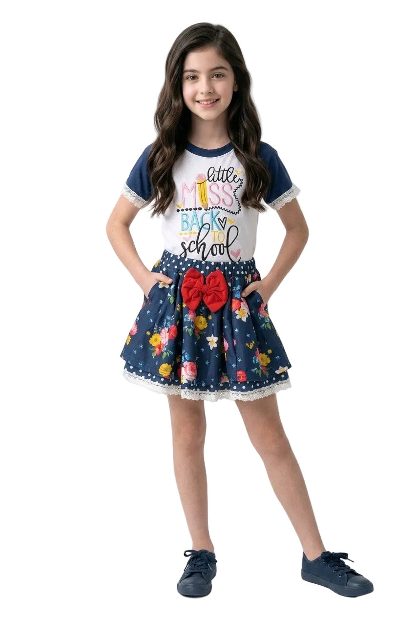 Young girl wearing a 'Back to School' outfit with a skirt and top on a white background