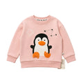 A light pink long-sleeve sweatshirt for kids, featuring a 3D applique penguin design with an orange beak and feet, a white outline crown, and a constellation graphic on the chest.