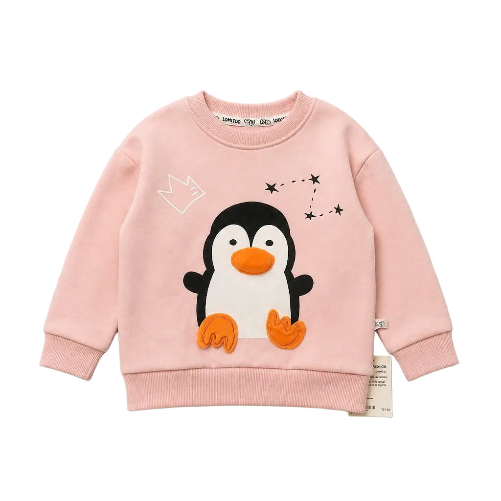 A light pink long-sleeve sweatshirt for kids, featuring a 3D applique penguin design with an orange beak and feet, a white outline crown, and a constellation graphic on the chest.