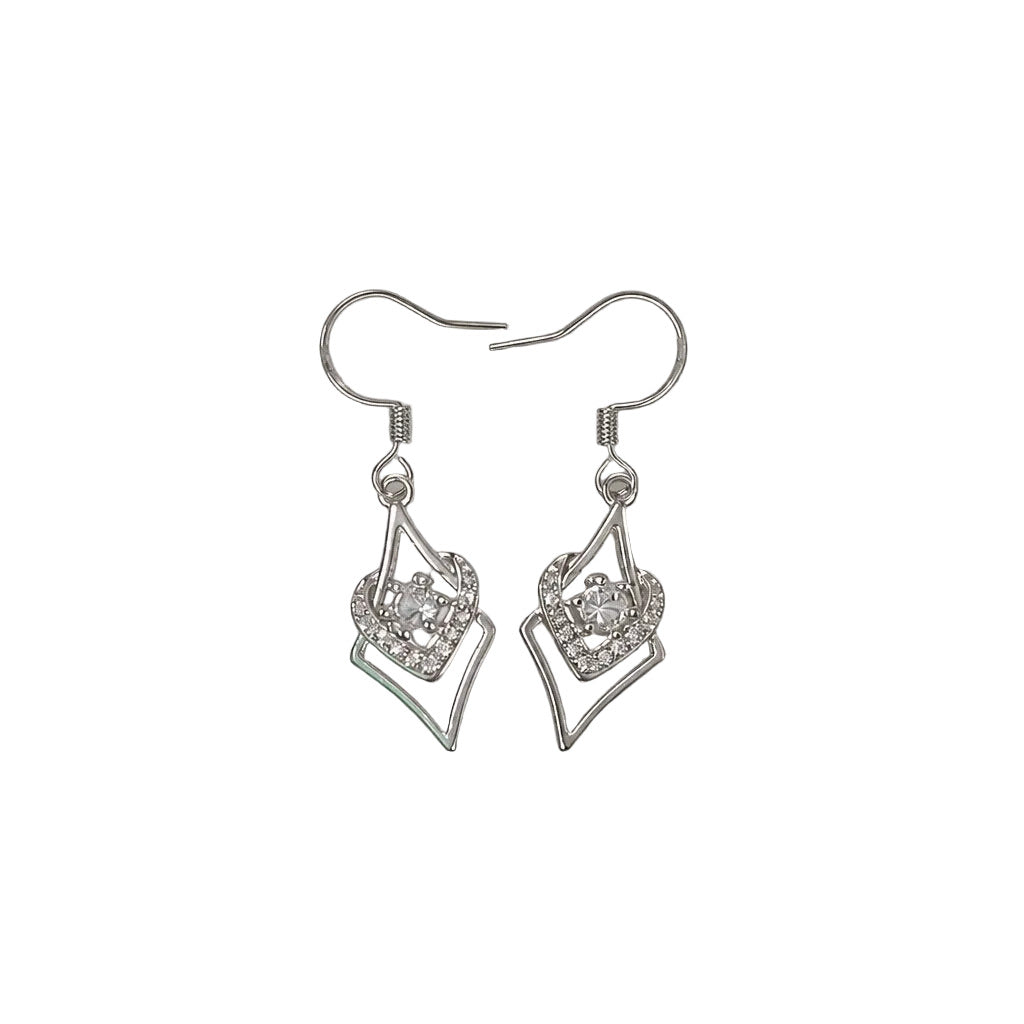 Pair of silver earrings with clear gemstones on a light gray background