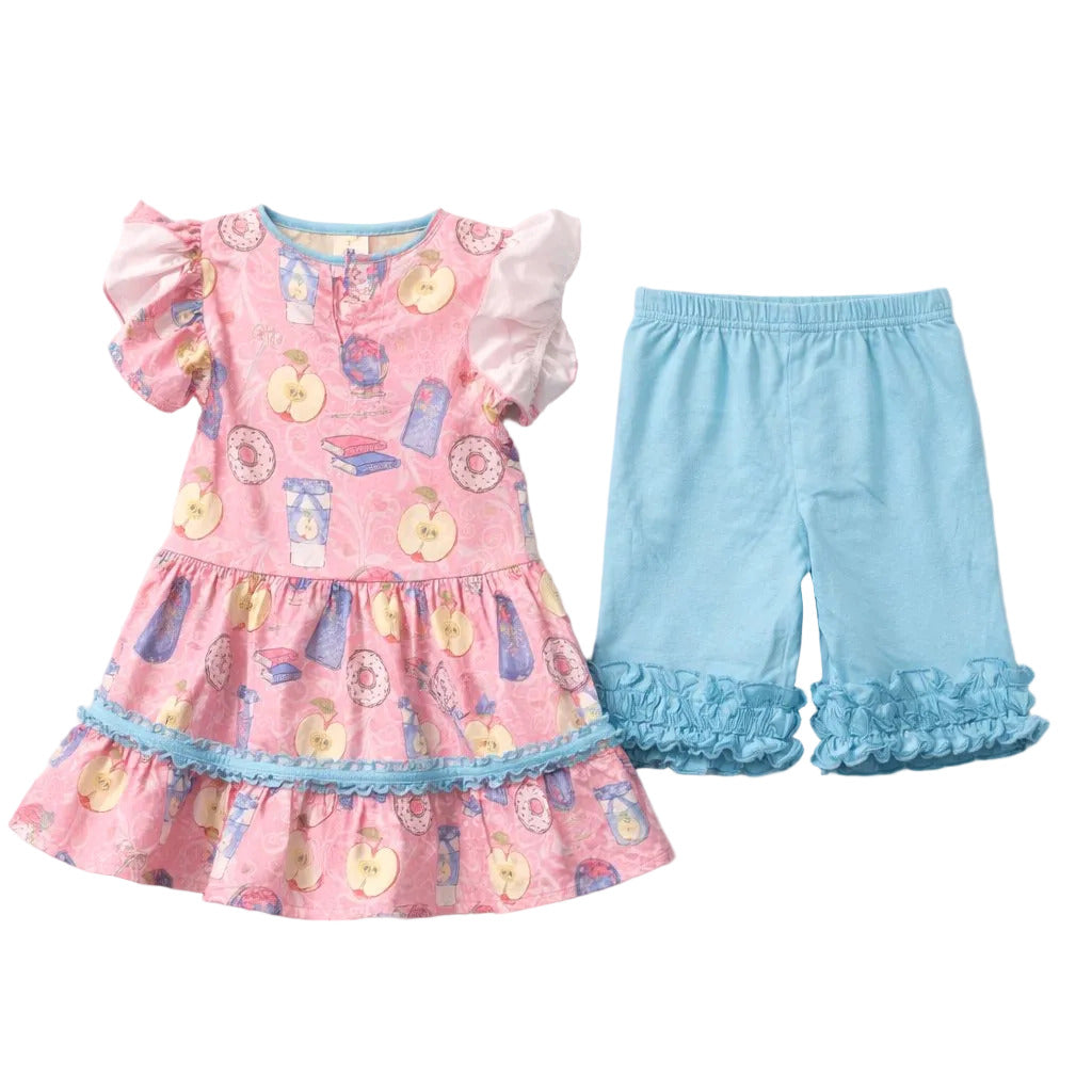 Pink dress with ruffled details and blue pants on a white background