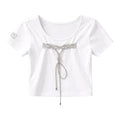 White t-shirt with a decorative bow on a light gray background