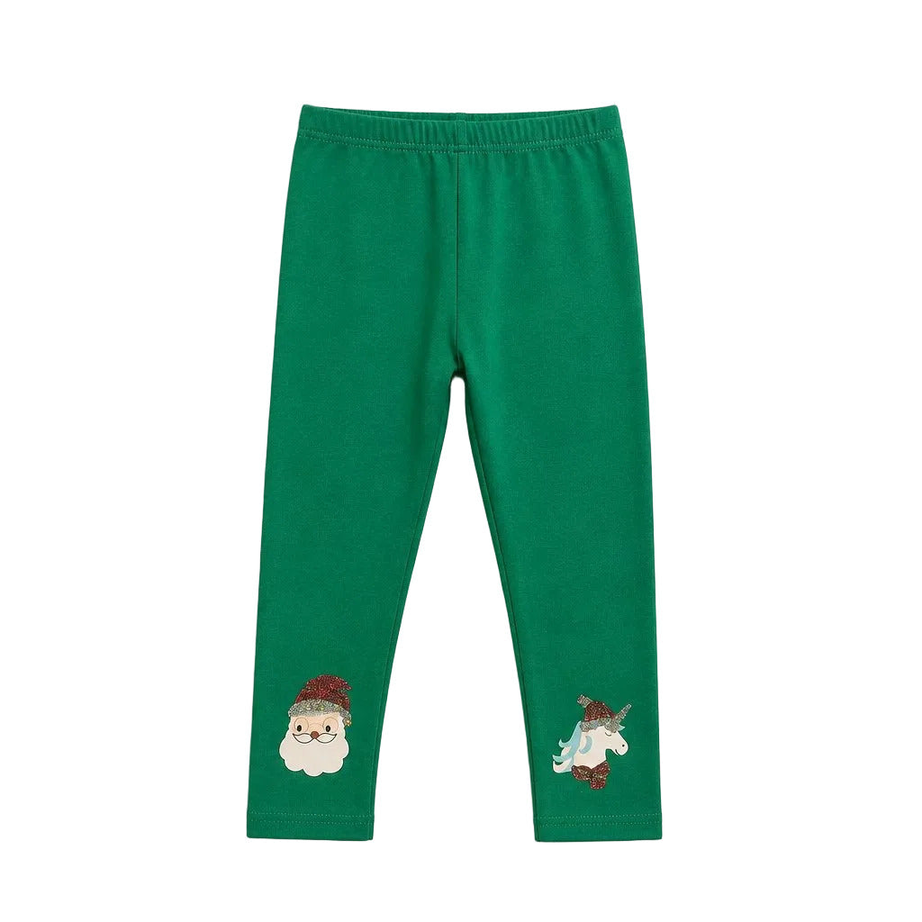 Green children's leggings with embroidered holiday motifs, featuring a Santa Claus face on the left ankle and a small unicorn on the right ankle, shown flat on a light gray background.