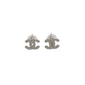 Silver Chanel earrings on a light gray background