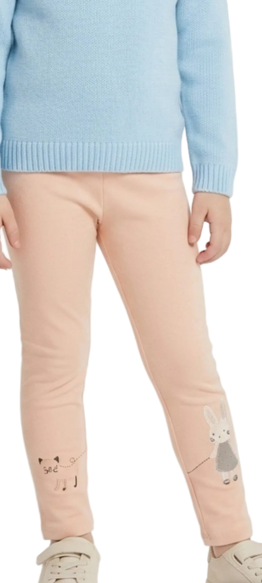 Person wearing a light blue sweater and pink pants with cat designs on a white background