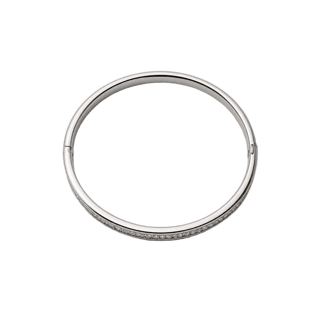 Silver bangle on a light gray background