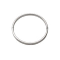 Silver bangle on a light gray background