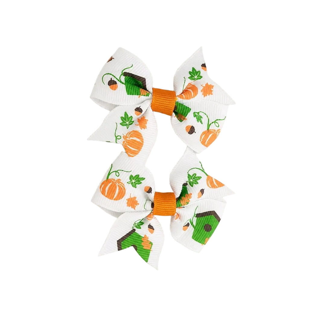 Four decorative bows with Halloween-themed designs on a light gray background