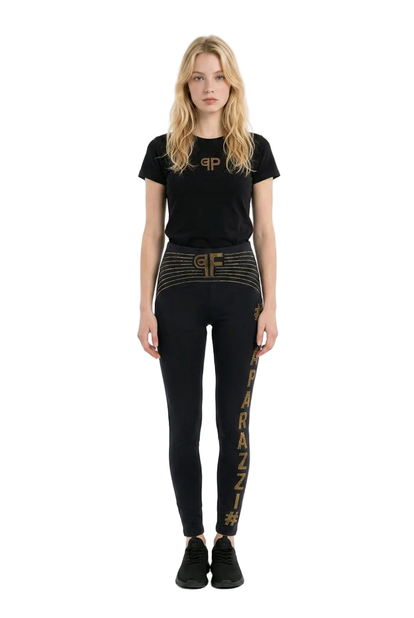 Woman wearing a black t-shirt and leggings with visible branding on a white background