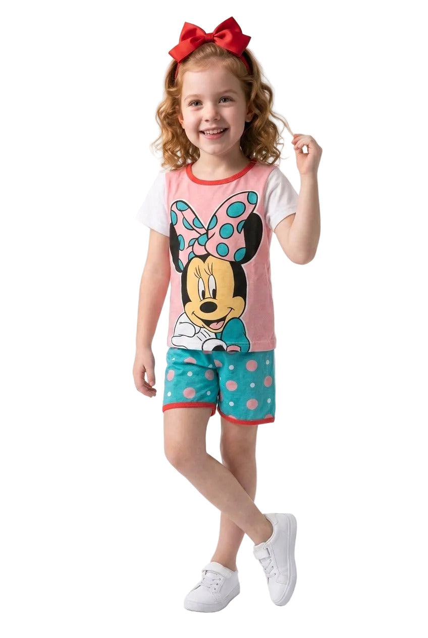 Young girl wearing a Minnie Mouse outfit with a pink shirt and blue shorts on a white background