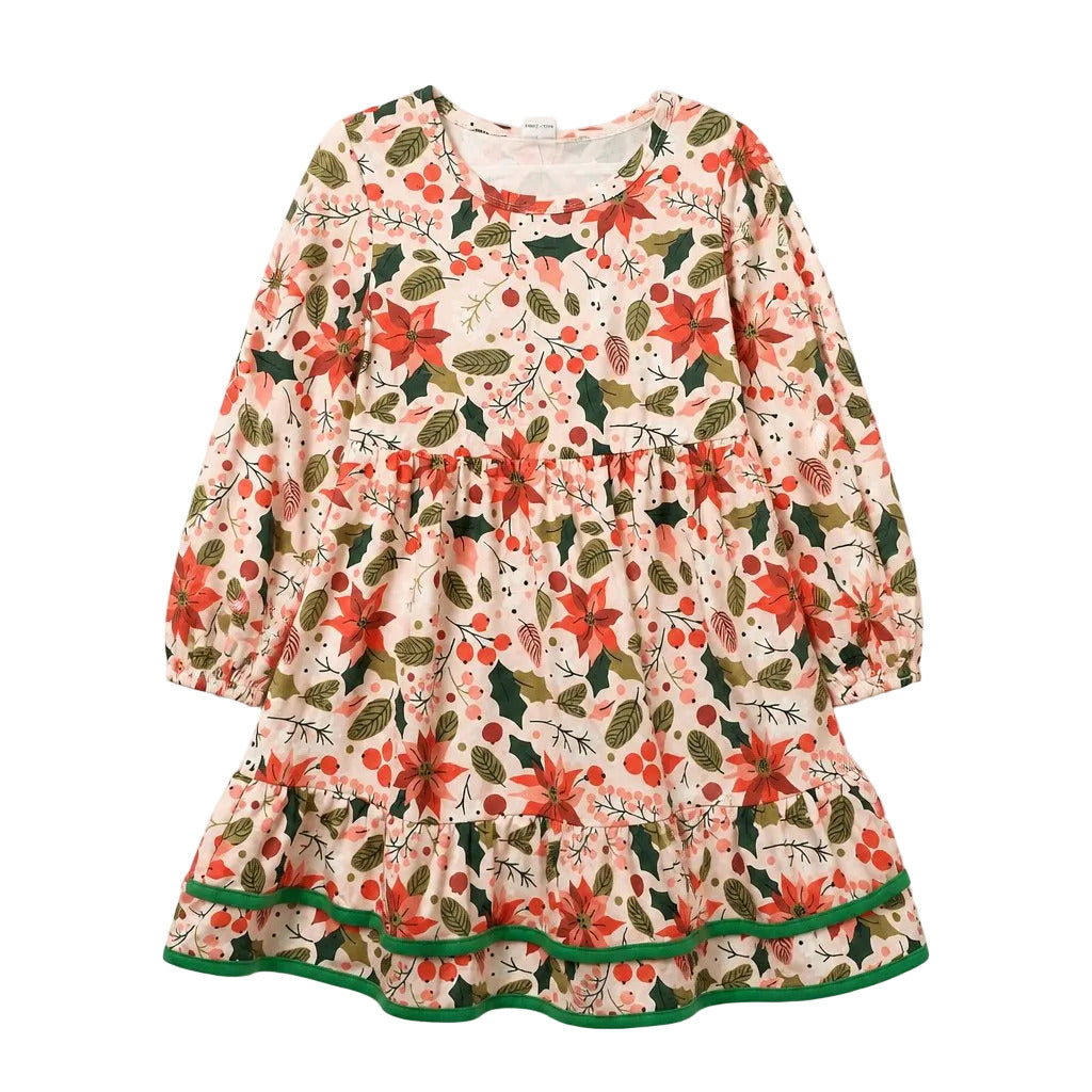 A long-sleeve tiered dress with a festive floral print featuring red poinsettias, green holly leaves, pinecones, and berries on a cream background, finished with a green ruffled hem.