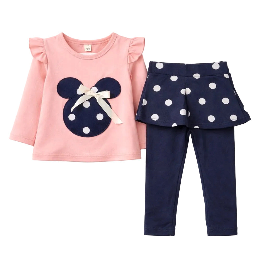 A toddler girl's two-piece outfit set featuring a light pink long-sleeve top with a navy blue mouse-head applique and white bow, paired with navy blue leggings and matching navy polka-dot ruffled shorts.